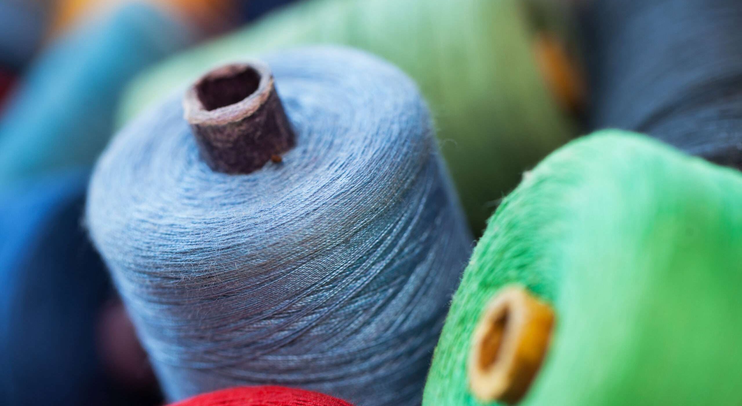 Closeup image of various colour thread rolls